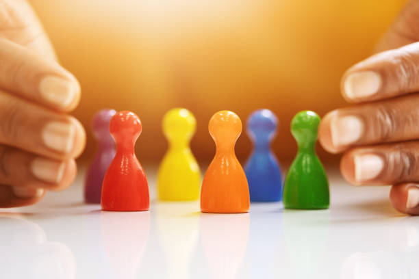 istock Diversity And Inclusion Concept. Hand Protecting Pawns 1335440119