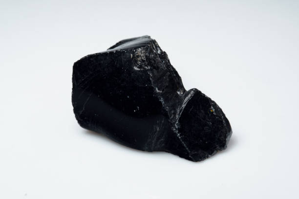 istock Natural black obsidian stone on white background 1335440243