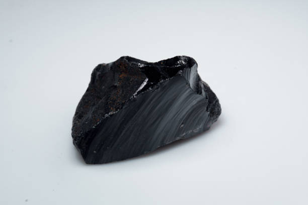 istock Natural black obsidian stone on white background 1335440270