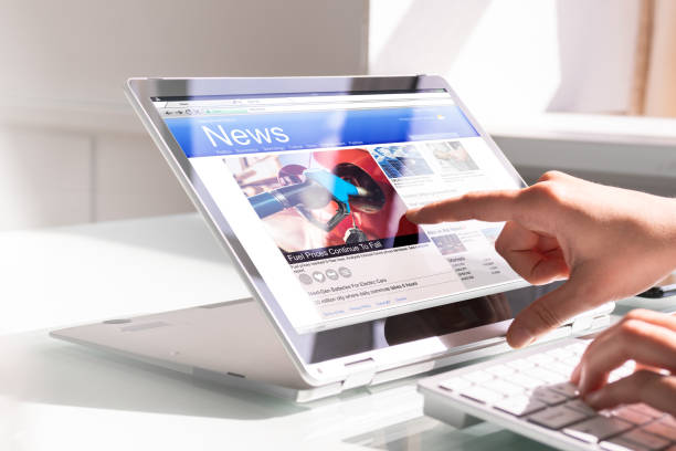 istock Watching News On Screen. Reading Newspaper Website 1335442935
