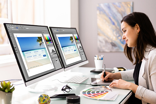 Graphic Web Designer Using Multiple Monitors Desktop Computer