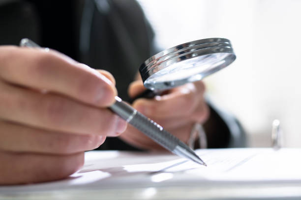 istock Audit And Fraud Investigation. Auditor Using Magnifying Glass 1335442960
