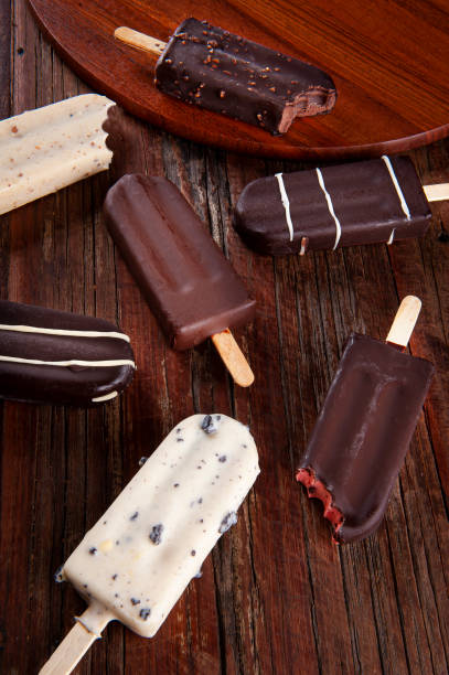 istock Composition with chocolate popsicles on wooden background. Top view 1335446564