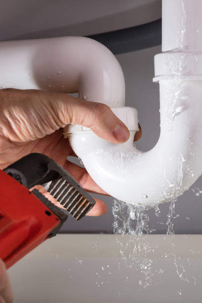 istock Plumber Fixing Sink Pipe With Adjustable Wrench 1335446651