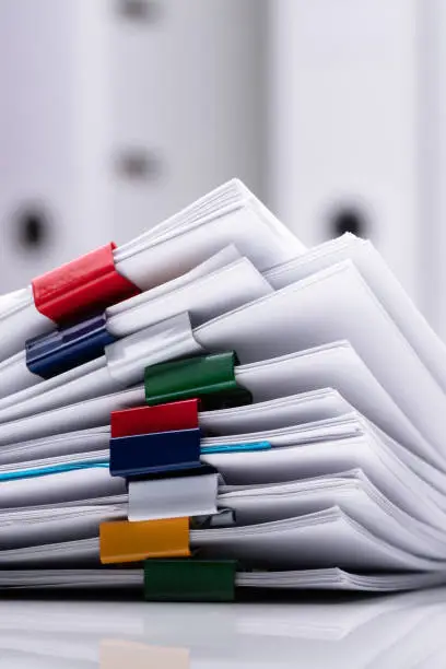 Photo of Stacked Documents And Eyeglasses