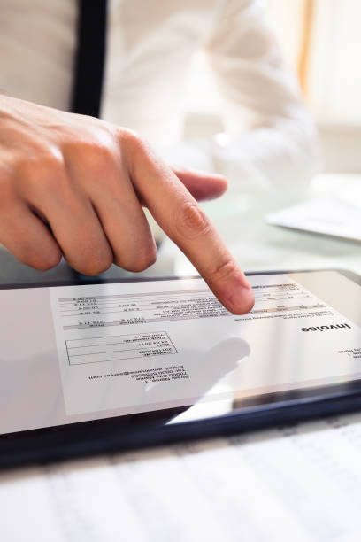 istock Businessperson Analyzing Invoice On Digital Tablet 1335446676