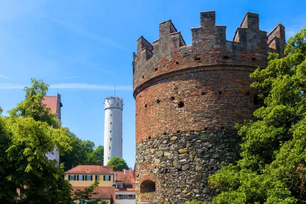 Towers of Ravensburg city, Baden-Wurttemberg, Germany, Europe. Old buildings in Ravensburg downtown in summer. Medieval structure with battlements in foreground, and Mehlsack in distance.