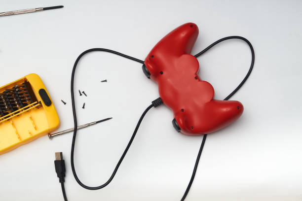 istock video game control with screwdriver and screws 1335453103