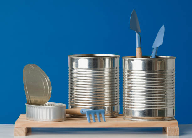 istock Aluminum cannons used as containers for growing plants on blue background 1335455315