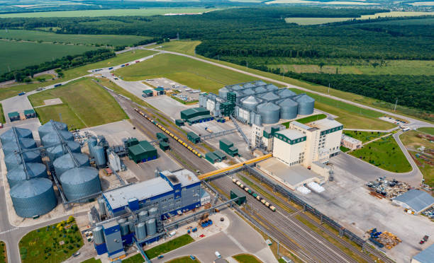 istock Modern granary elevator. Silver silos on agro-processing and manufacturing plant. Agricultural products, flour, cereals and grain. Aerial view panorama 1335457253