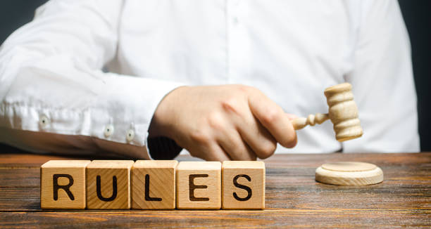 istock A man knocks a hammer publishes new rules and laws. Setting clear rule and restrictions. Leadership and discipline. Authoritarianism, tight control framework. Norms and laws in society, state 1335459182