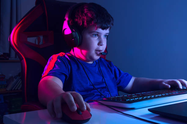 Boy playing videogame stock photo