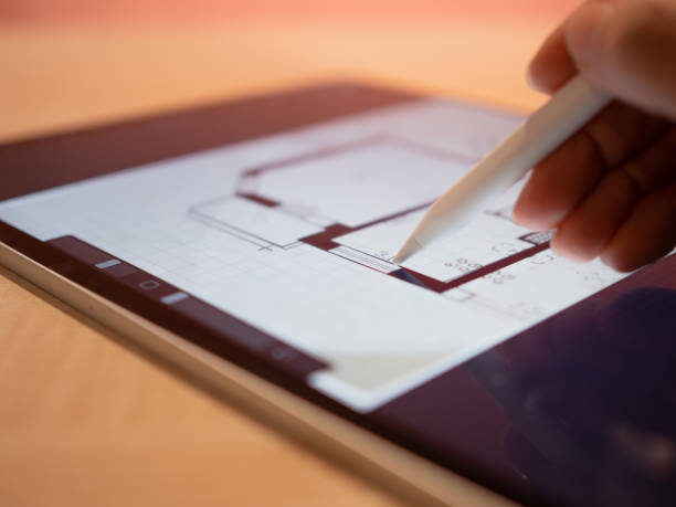 istock An architectural engineer is working on a floor plan of a building on a mobile 1335466778