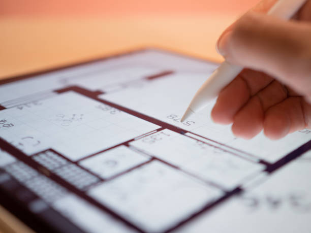 Interior Designer is working on a floor plan of a building on a mobile