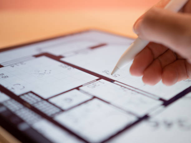 interior designer is working on a floor plan of a building on a mobile - building contractor engineer digital tablet construction imagens e fotografias de stock