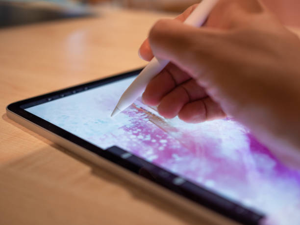 istock Drawing on a graphic tablet, the artist's hand draws an abstract pattern 1335466800