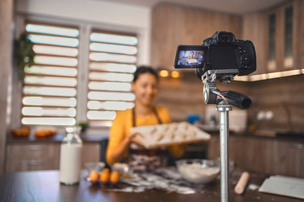 istock Woman filming vlog while kneading pastries at home in the kitchen 1335468492