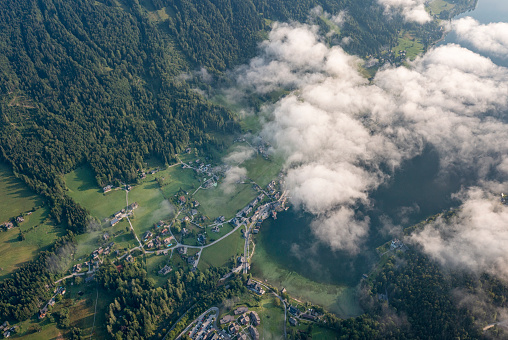 The beautiful Lake Grundlsee waking up in clouds on this stunning summer day. Aerial view. Converted from RAW.