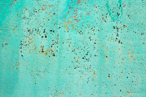 Photo of Pattern of old painted metal surface. Rusty metal, peeling paint, green tones, bright colors.