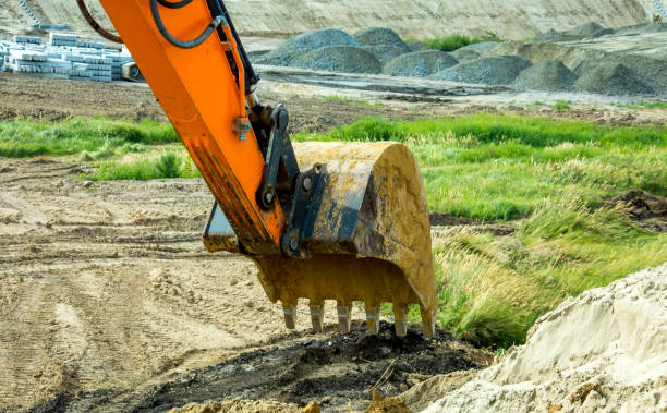 istock Closeup bucket of backhoe digging the soil at construction site. Crawler excavator digging on demolition site. Excavating machine. Earth moving equipment. Excavation vehicle. 1335472122