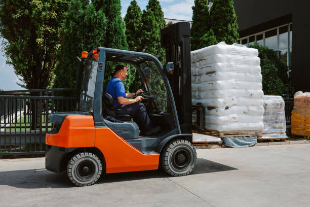 istock Man driving a forklift at the recycling facility warehouse 1335473344