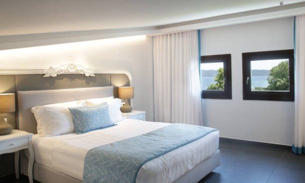 istock Cozy and elegant bedroom. King size bed with bedside lamp. 1335473407