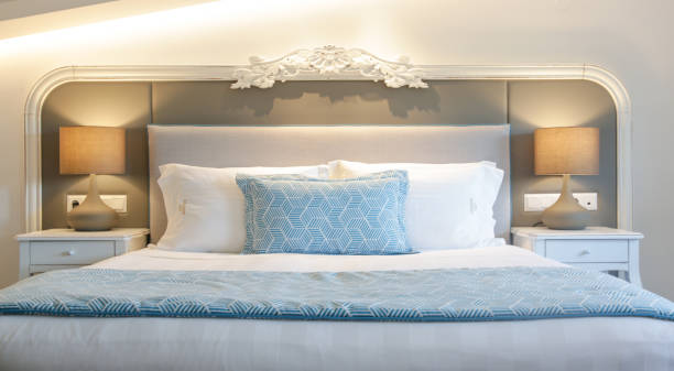 istock Cozy and elegant bedroom. King size bed with bedside lamp. 1335473493