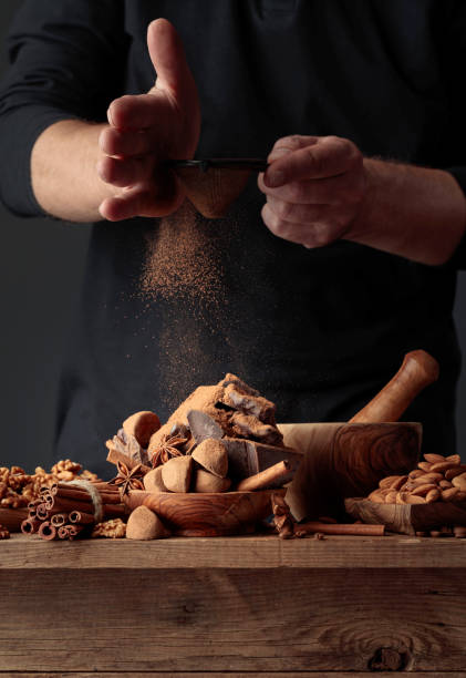istock The cook sprinkles the chocolates with cocoa powder. 1335474630
