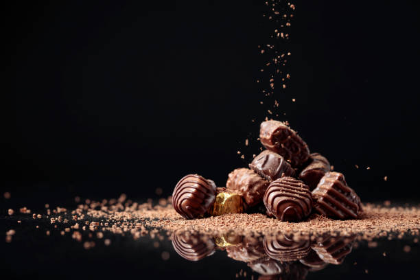 istock Chocolate candies on a black background sprinkled with chocolate chips. 1335475429