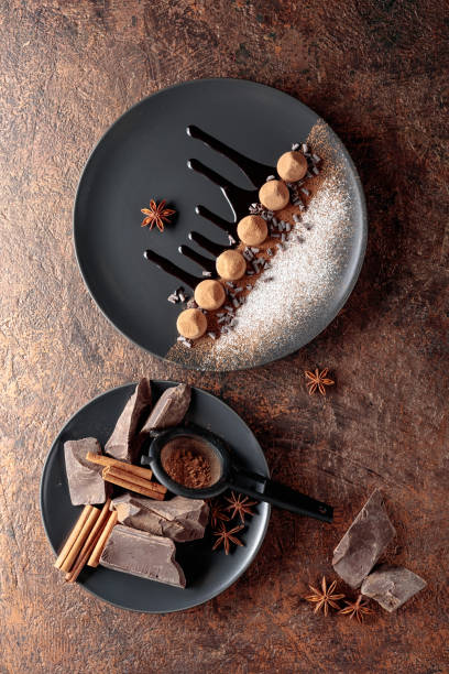 istock Chocolate truffles on a black plate with chocolate sauce. 1335475454
