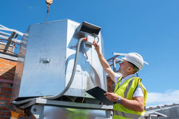 engineer with clipboard checking the installation of the ventilation system - aeration imagens e fotografias de stock