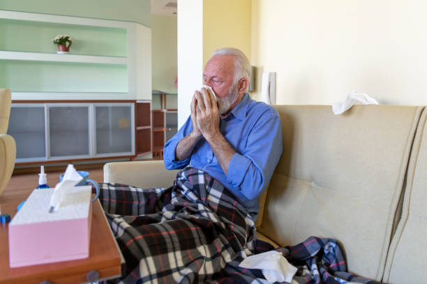 istock An Older Man has Problems with Respiratory System and He is Blowing a Nose in Paper Handkerchiefs. 1335489696