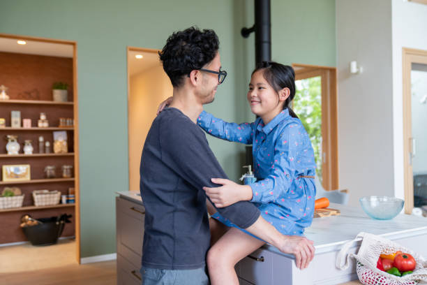 istock Young girl relaxing with her father in the kitchen 1335497285