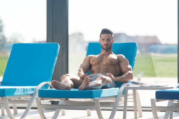 istock Young Man Lying On A Sun Lounger 1335500636