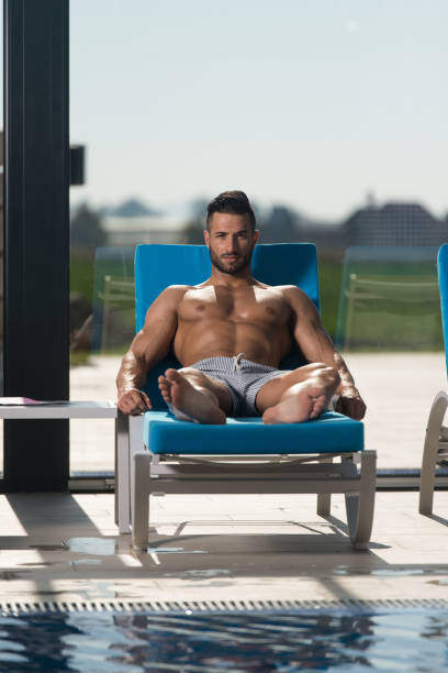 istock Young Man Lying On A Sun Lounger 1335500638