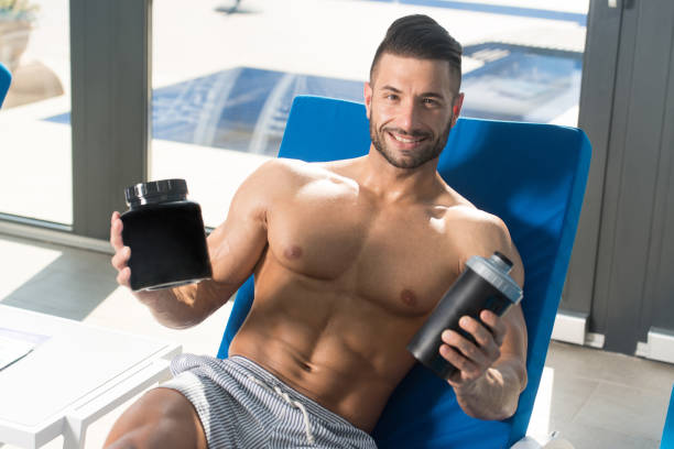 istock Athlete Resting on Lounger With Supplements and Shaker 1335500651