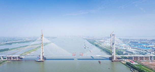 aerial view of cable-stayed bridge under construction on Yangtze river, Jiujiang city, Jiangxi province, China.
