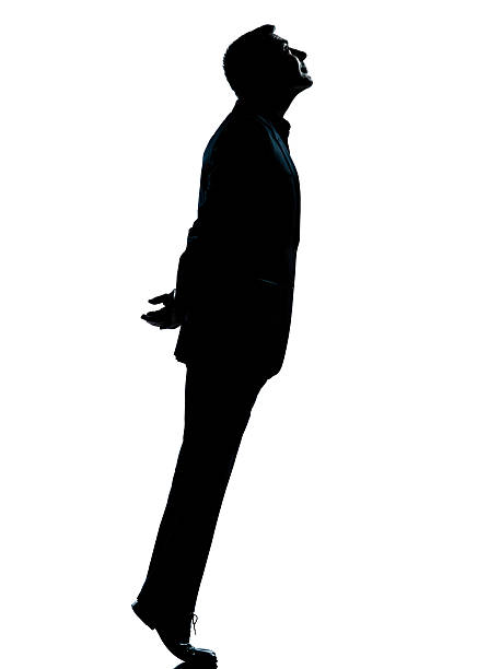 istock one business man silhouette tiptoe looking up 133550643