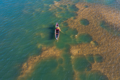 Drone view of a fisherwoman is putting fishing trap on Tra Khung river, Quang Ngai province, central Vietnam