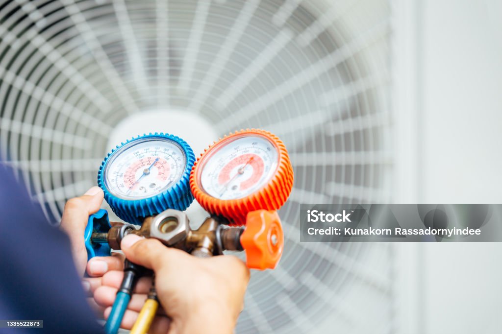 Air Conditioning Technician and A part of preparing to install new air conditioner. Air Conditioner Stock Photo