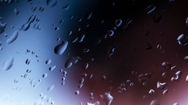 istock Abstract image of water droplets on glass surface reflecting with multicolored background. 1335525206