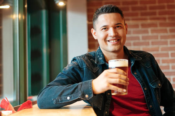 istock Happy attractive Hispanic man enjoying a cold beer 1335526032