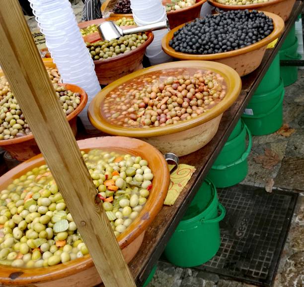 istock Market stall selling olives 1335527794