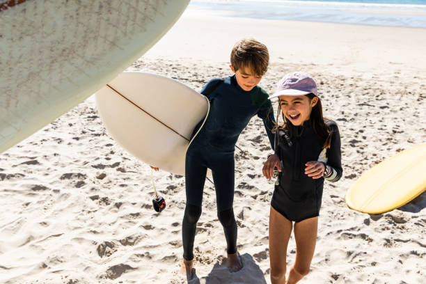 istock Brother and sister play on the beach 1335528486