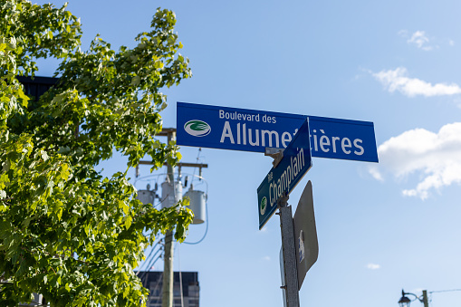 Gatineau, Canada - August 2, 2021: Allumettieres boulevard and champlain street sign in French with arrow at crossroads in Gatineau, Quebec