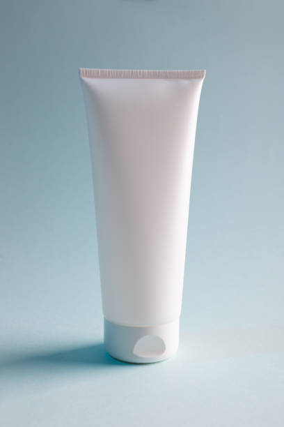 istock White cream or toothpaste tube on a blue background, mock up for your design, front view 1335531226