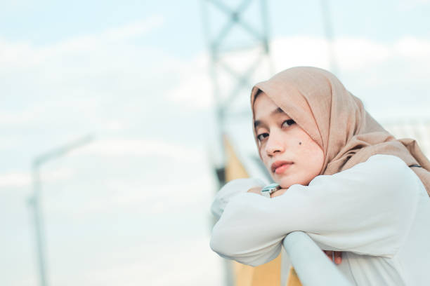 istock Young woman distraught at park bridge outdoor 1335535265