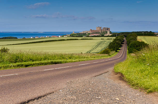 Road to Bamburgh Castle Approach to Bamburgh and its Castle Bamburgh stock pictures, royalty-free photos & images
