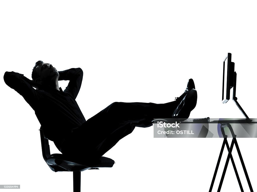 one business man computer computing relaxing silhouette one caucasian business man computer computing relaxing  silhouette Full length in studio   on white background Adult Stock Photo