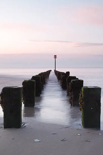 Breakwater groynes in early morning light at Bridlington on the coast of East Yorkshire, England.